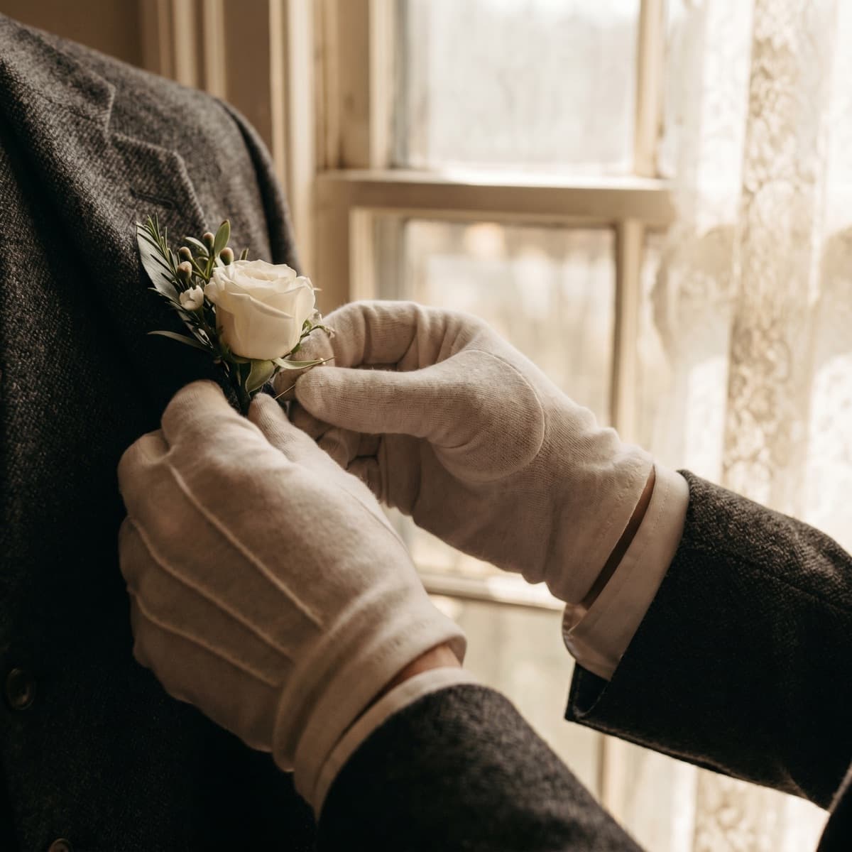 A boutonniere pinned to a wool lapel