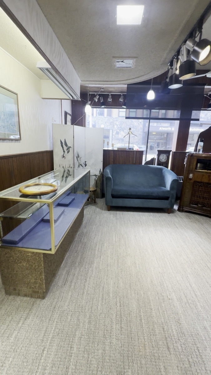 The Columbia fitting lounge with Art Deco settee and glass display case
